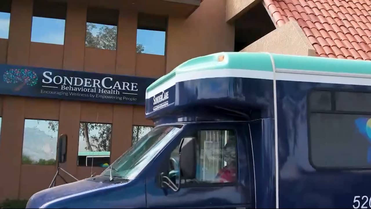blue medical bus passes SonderCare Behavioral Health Services building
