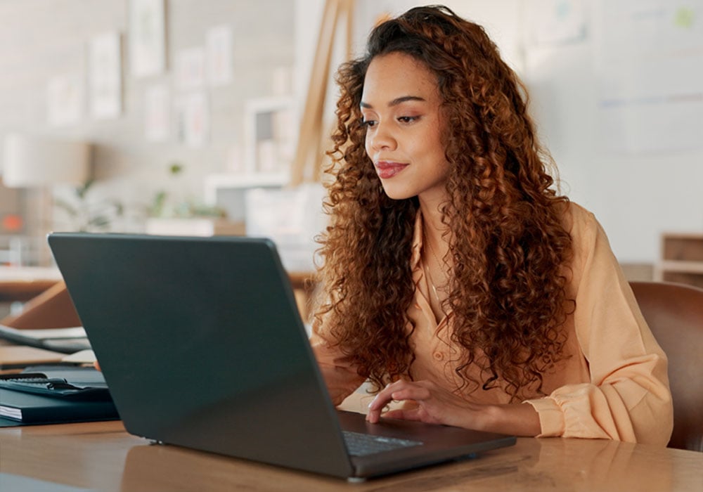 woman filling BOI reporting on laptop