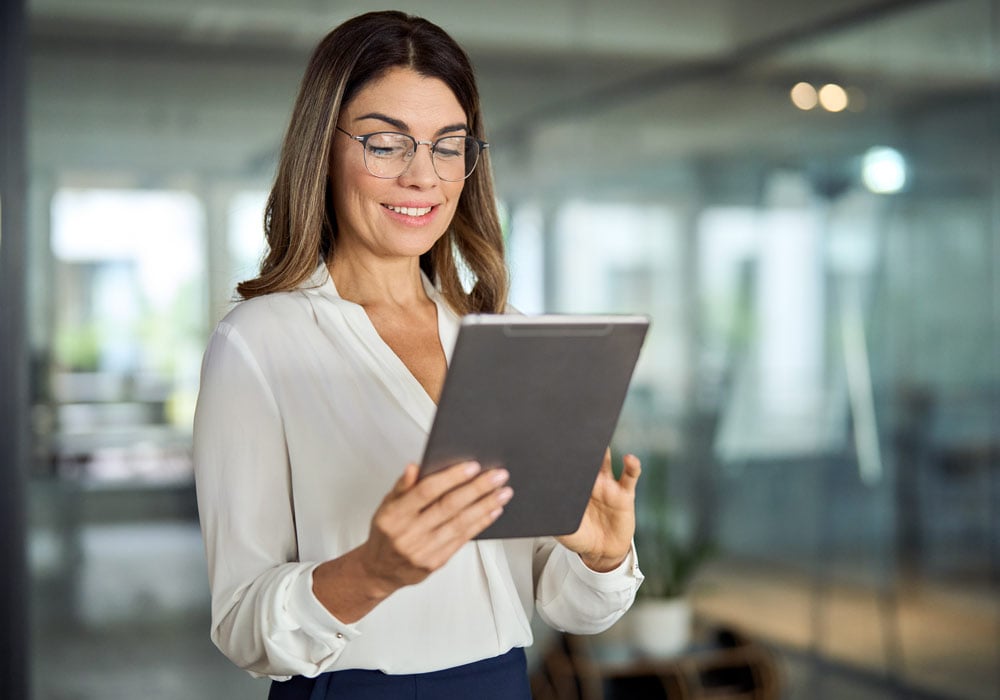 Professional woman checking on compliance approval on a tablet