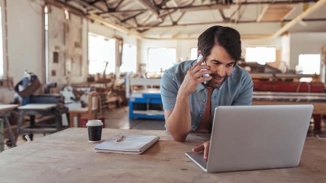 a small business owner researching on his laptop health insurance options for his employees