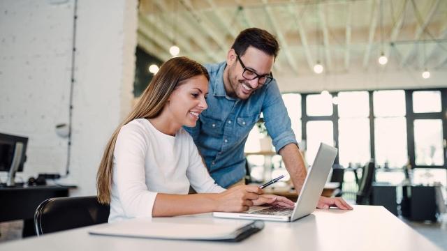 people looking at laptop and discussing hr solutions for their business