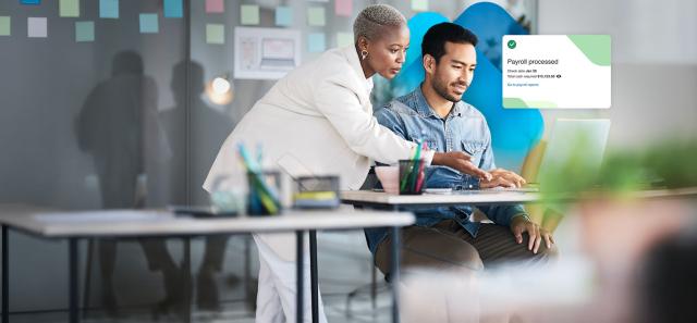 Coworkers working on payroll with Paychex