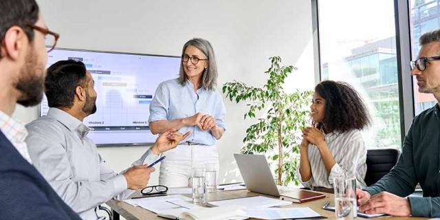 a group of employees discussing business strategies