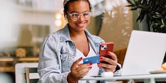 employee using her card on an online transaction from smartphone