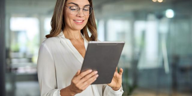 Professional woman checking on compliance approval on a tablet