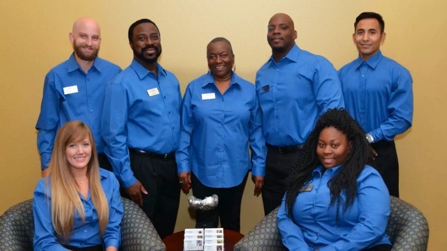 Staff of 8 employees in blue shirts