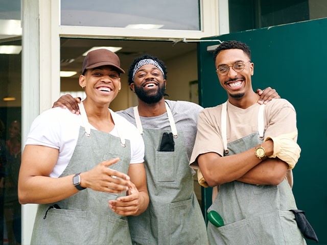 happy employees standing in front of their restaurant