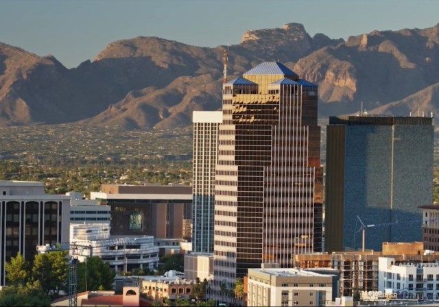 Desert city skyscraper and mountains in distance