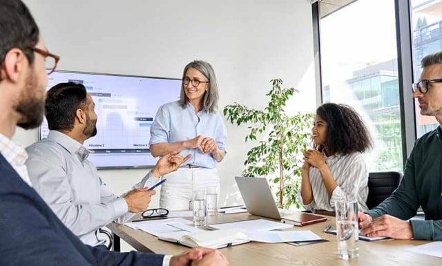 a group of employees discussing business strategies