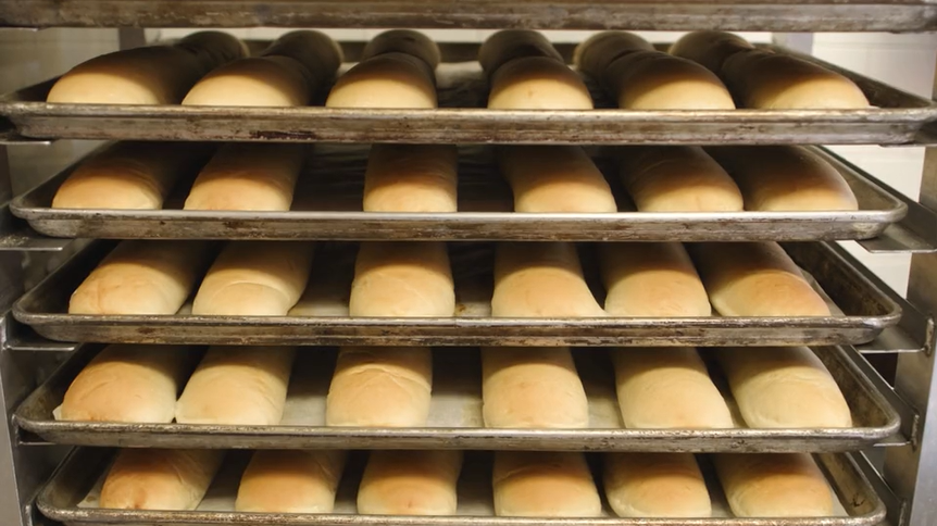 Silver trays holding sub sandwich rolls or buns