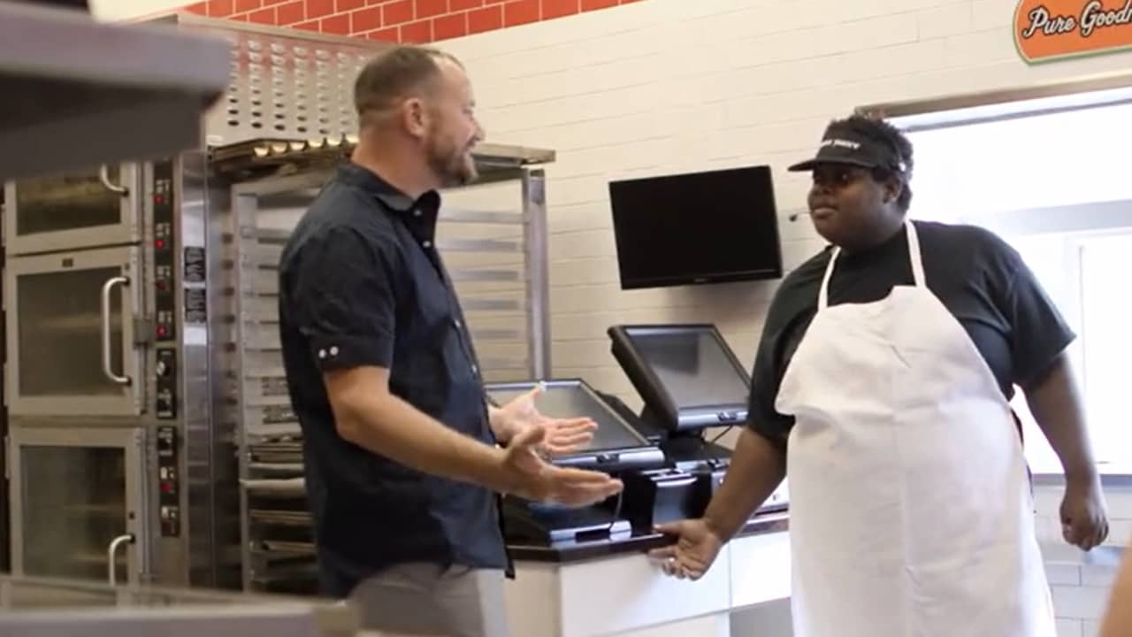 owner and staffer chat at checkout of sub shop franchise