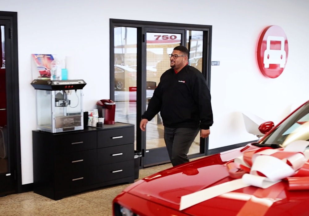 Co-founder walks through auto showroom at You Drive Auto