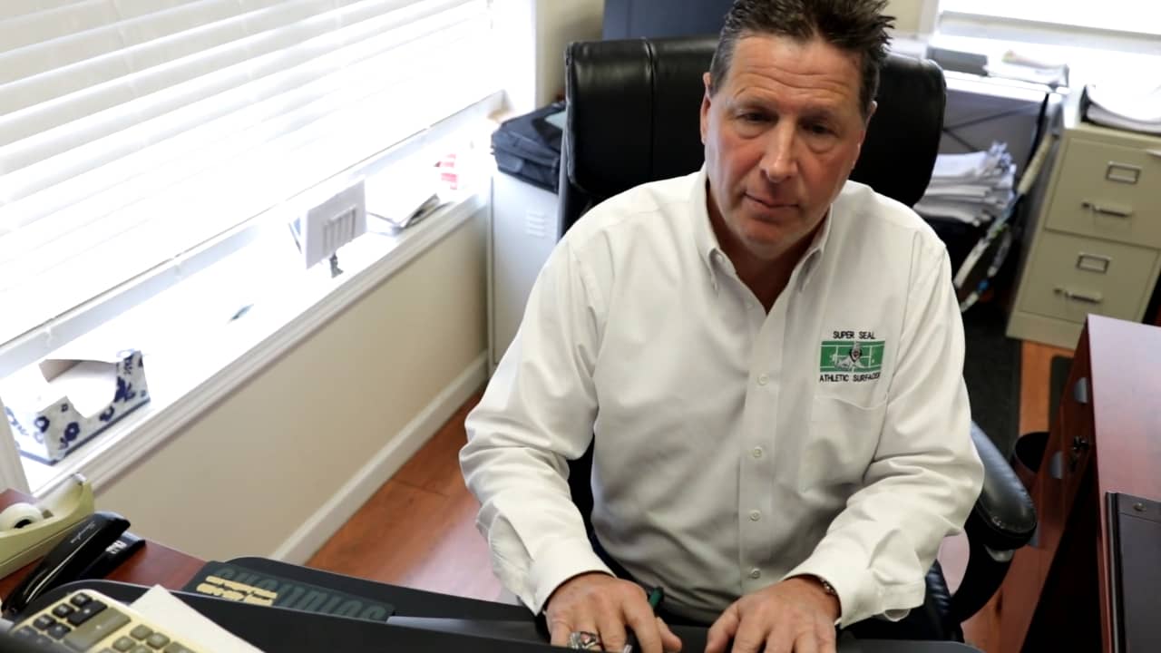 Greg Duffy, owner of Super Seal Sealcoating business, works on his computer