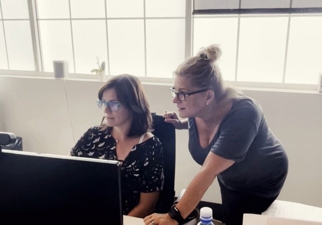 women look at computer together